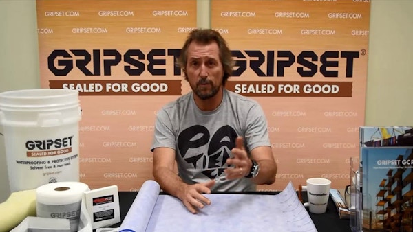 A man sits at a table with Gripset products laid out. There are two Gripset: Sealed For Good signs behind him.