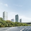 There is a view of skyscrapers in the background. In the front is a solar panel.