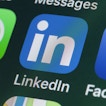A phone screen displays the LinkedIn app icon.