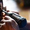 A pair of hands works with a drill.