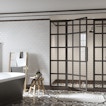 There is a white bathroom with a tub on the left, a shower in the center, and a sink on the right.