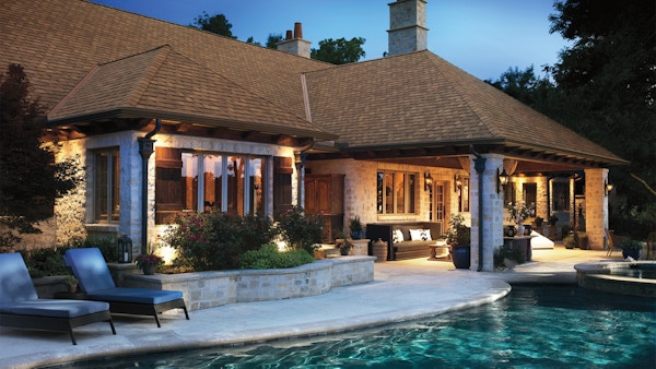 There is a house with an outdoor pool.