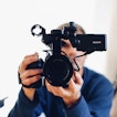 A person holding a camera points it directly forward.