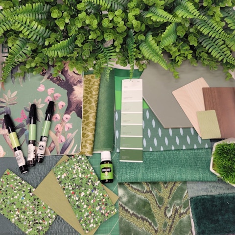 This image shows paint samples, fabric swatches, three markers and greenery laying on a table.