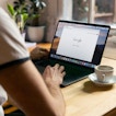 This image depicts a person using Google search on their laptop.